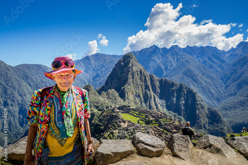 A male Traveler  Posing at the Inca ruins of Machu Picchu, UNESCO World Heritage Site in Cusco Region.