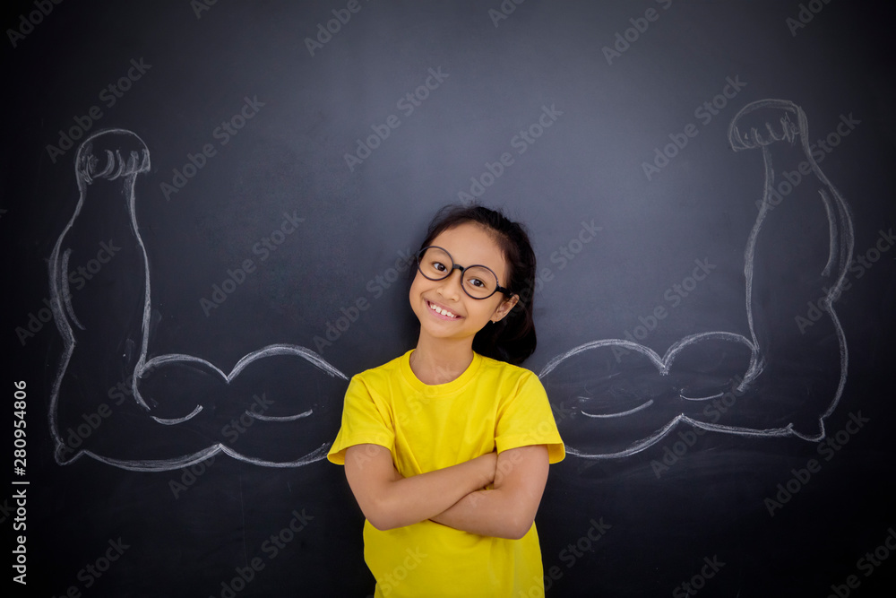 Confident schoolgirl showing her biceps
