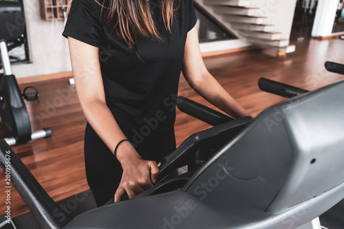 group of young people running on treadmills in modern sport gym