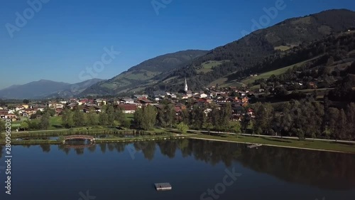 Wallpaper Mural Flight around of Uttendorf town over calm lake at sunny summer morning, in Land Salzburg, Austria. Torontodigital.ca