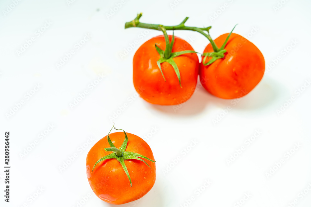 Fresh red tomato with green leaves isolated on white background Clipping Path. Full depth of field. Fresh red tomato with green leaves isolated on white background Clipping Path. Full depth of field.