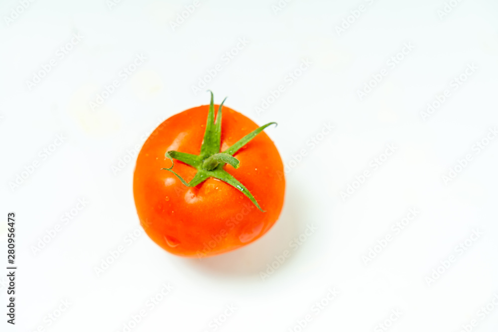 Fresh red tomato with green leaves isolated on white background Clipping Path. Full depth of field.
