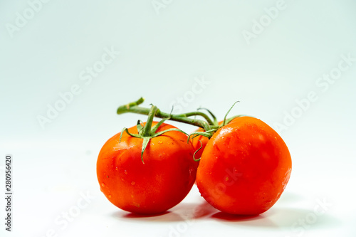 Fresh red tomato with green leaves isolated on white background Clipping Path. Full depth of field.