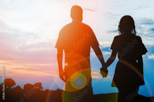happy couple by the sea on nature silhouette background