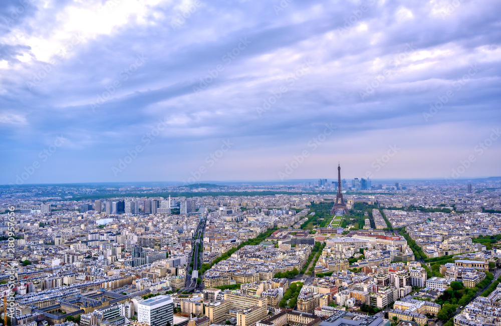 An aerial view of the Eiffel Tower and Paris, France at dusk..