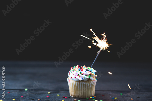Up Close single cupcake with white icing and a sparkler
