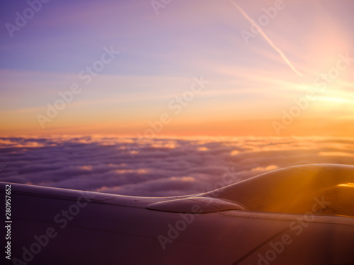 Airplane flight view from plane window in the morning sunrise