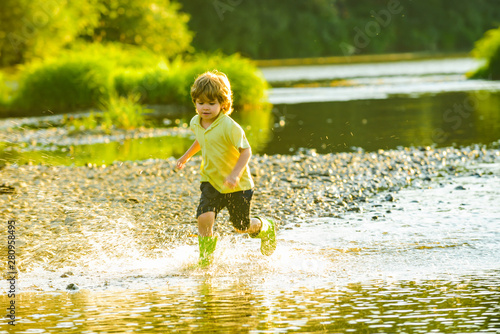 Happy kid on nature. Cute child having fun on River.