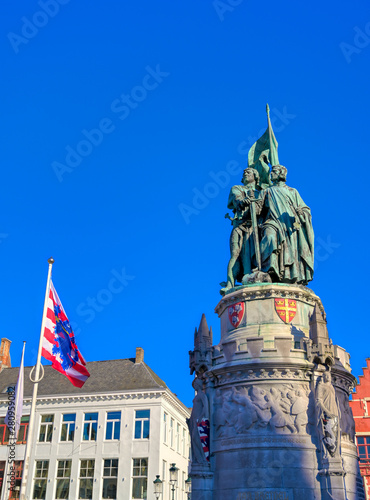 The Jan Breydel and Pieter de Coninck statue located in the historical city center and Market Square  Markt  in Bruges  Brugge   Belgium on a sunny day.