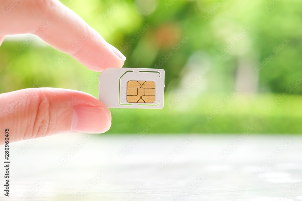 Fototapeta premium Hand holding sim card.