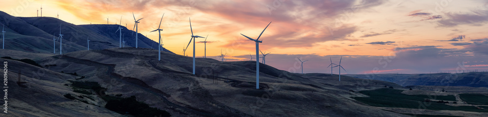 Fototapeta premium Beautiful Panoramic Landscape View of Wind Turbines on a Windy Hill during a colorful sunrise. Taken in Washington State, United States of America.