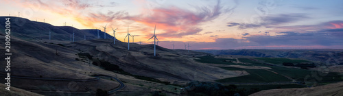 Beautiful Panoramic Landscape View of Wind Turbines on a Windy Hill during a colorful sunrise. Taken in Washington State, United States of America. © edb3_16