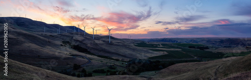 Beautiful Panoramic Landscape View of Wind Turbines on a Windy Hill during a colorful sunrise. Taken in Washington State, United States of America.