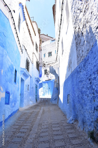 Blue narrow charming street through old town © Tres