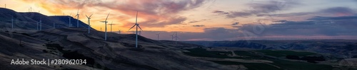 Beautiful Panoramic Landscape View of Wind Turbines on a Windy Hill during a colorful sunrise. Taken in Washington State, United States of America.