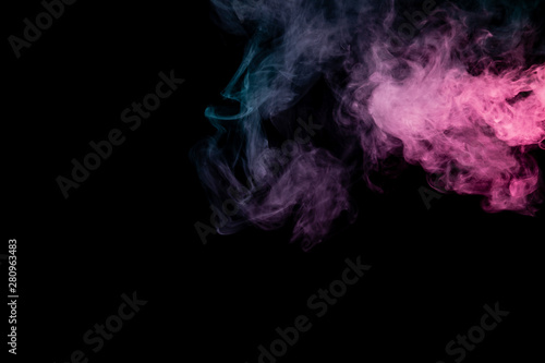 Colored background with winding clouds of smoke from patterns of different forms of pink, green and blue colors with tongues of flame on a black isolated background. Print for t-shirt. © Aleksandr Kondratov