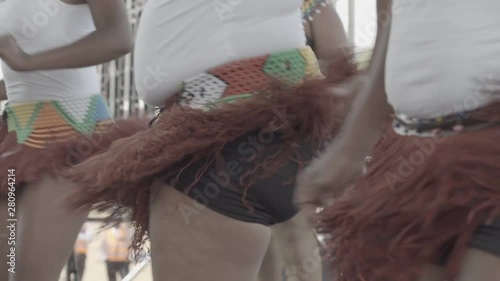 African Ladies doing a traditional African dance with beaded African skirts on. photo