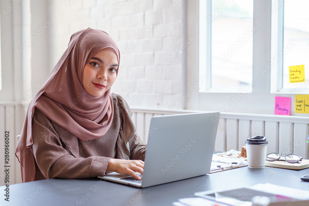 Happy professional arab businesswoman brown hijab working at home.