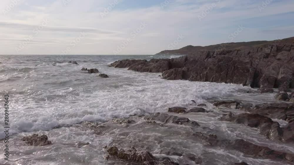 Waves Breaking at a Rocky Cove in Devon during Sunset Waves Breaking at a Rocky Cove in Devon during Sunset