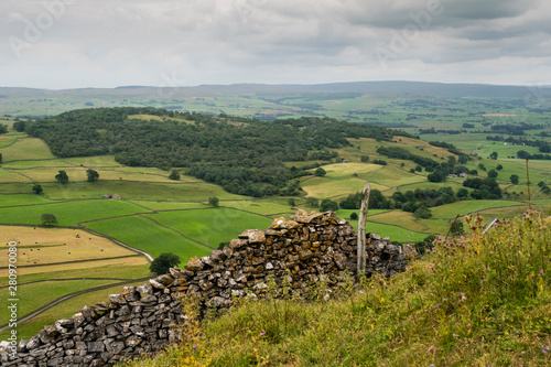 Moughton Scar is a vast and impressive limestone pavement full of interesting nooks and crannies. In the distance a moody Pen-y-ghent is seen in profile.