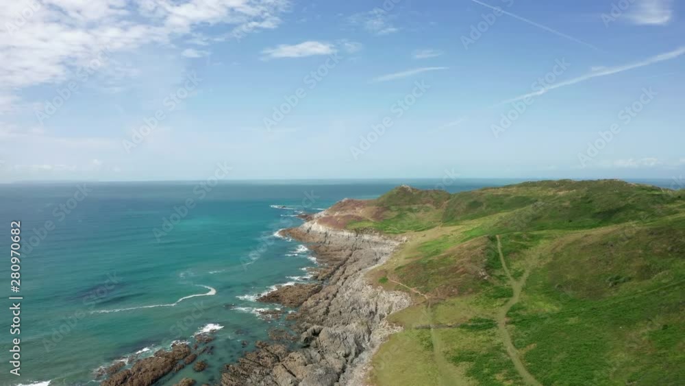 Rising Aerial Shot of a Coastal Headland in North Devon on a Summer’s Day Rising Aerial Shot of a Coastal Headland in North Devon on a Summer’s Day