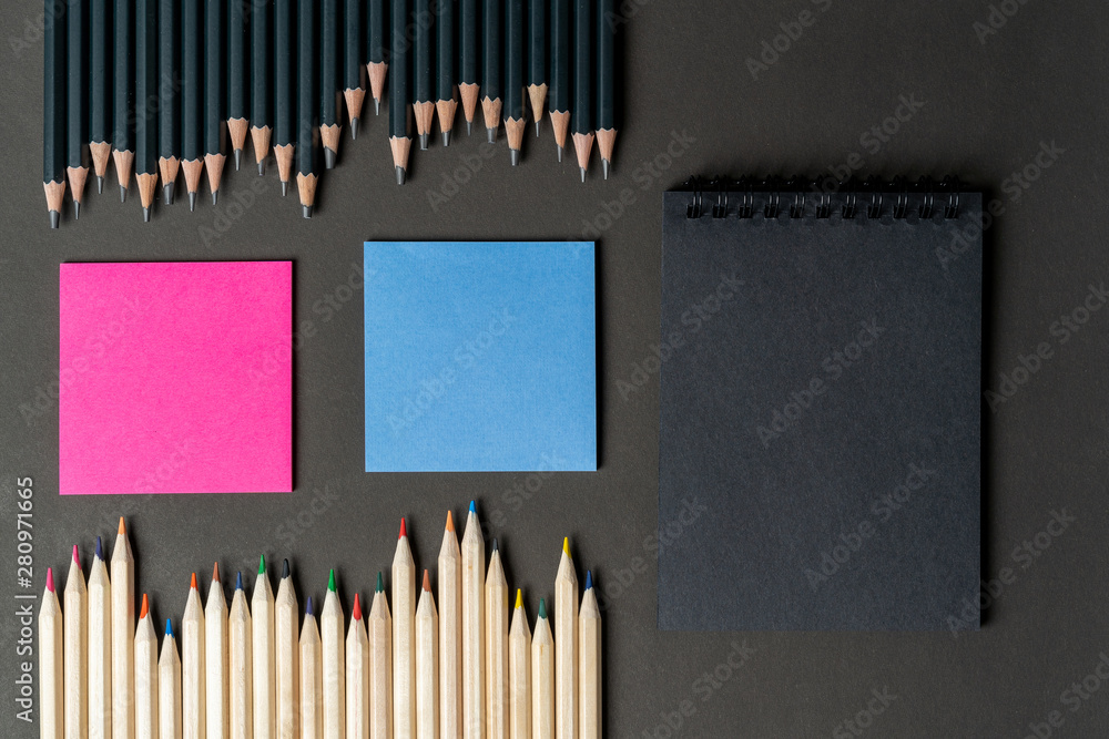 pencils white and black with pink and blue notes, black notebook. Mock up, copy space. ideas, variability. concept of difference and similarity women's and men's ideas and attitudes. pencils white and black with pink and blue notes, black notebook. Mock up, copy space. ideas, variability. concept of difference and similarity women's and men's ideas and attitudes.