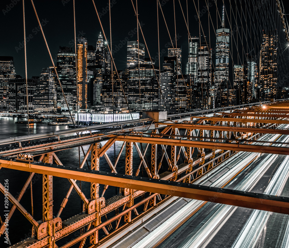 portrait view of lower Manhattan and long exposure Brooklyn Bridge traffic