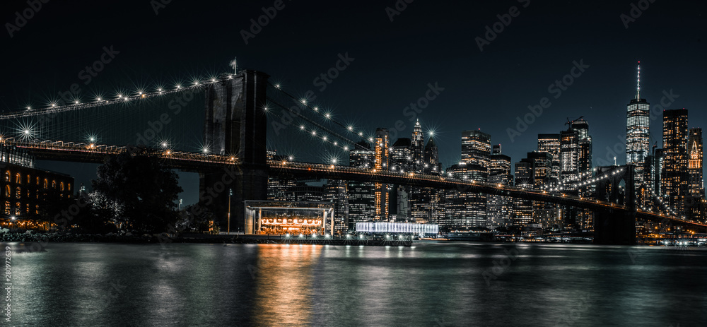 Brooklyn Bridge with tranquil waters and the city in the background