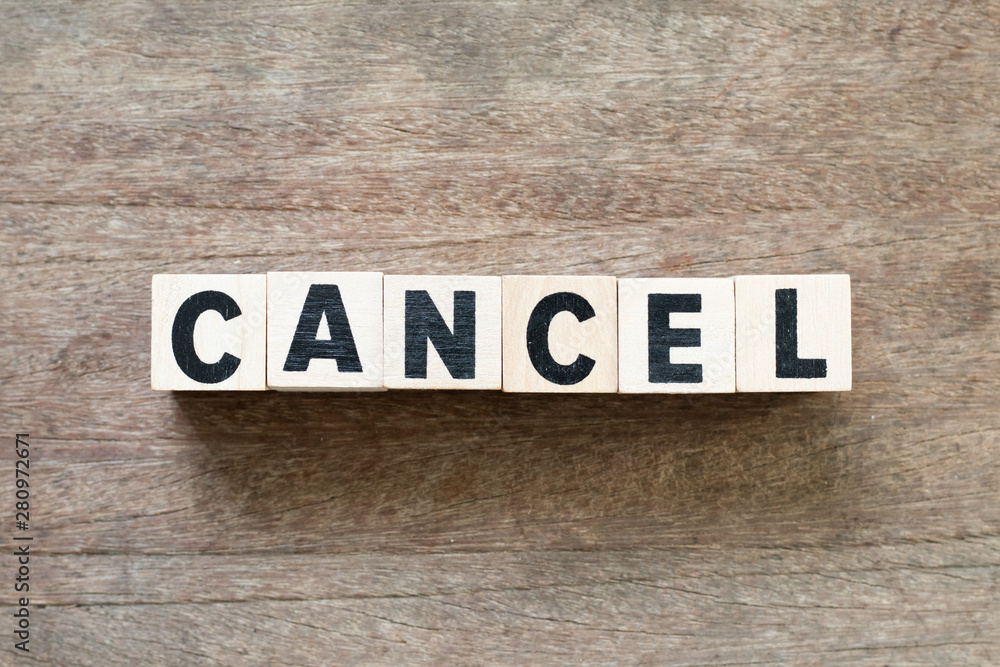 Fototapeta premium Letter block in word cancel on wood background