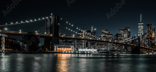Brooklyn Bridge with tranquil waters and the city in the background