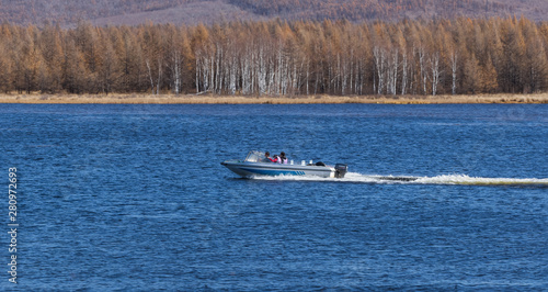 On the waters of the holiday lake, there are speedboats for tourists.