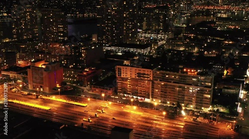 a slow aerial dolly shot forward, moving towards a closed train yard at night with bright orange yard lights photo