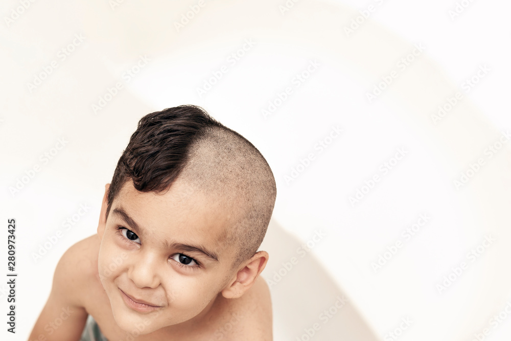 Six-year boy at haircutting at home. Father cut half of the son's hair off  at the bathroom Stock Photo | Adobe Stock