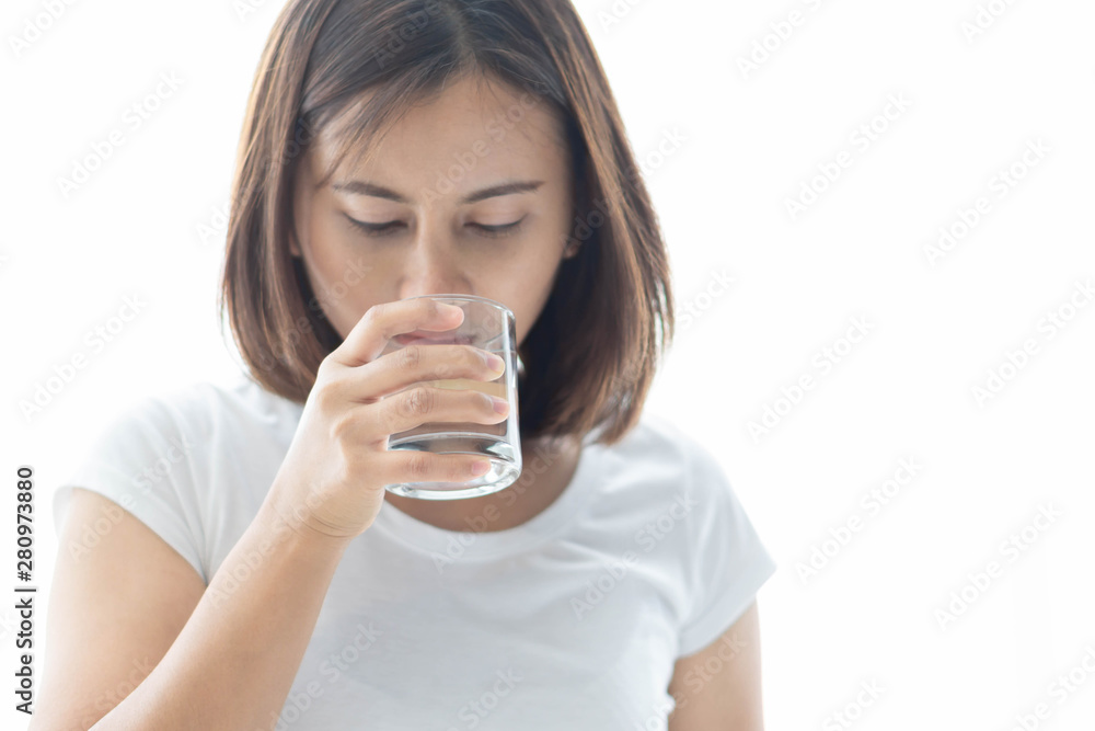 Close up woman drinking pure water from glass with light in the morning, Selective focus Close up woman drinking pure water from glass with light in the morning, Selective focus
