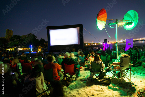 CINEMA ON THE BEACH AT NIGHT WITH STARS
