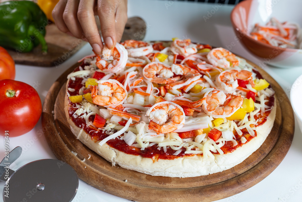 seafood pizza with shrimp on a table.