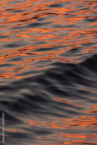 Vivid orange color on beautiful motion of wave at beach