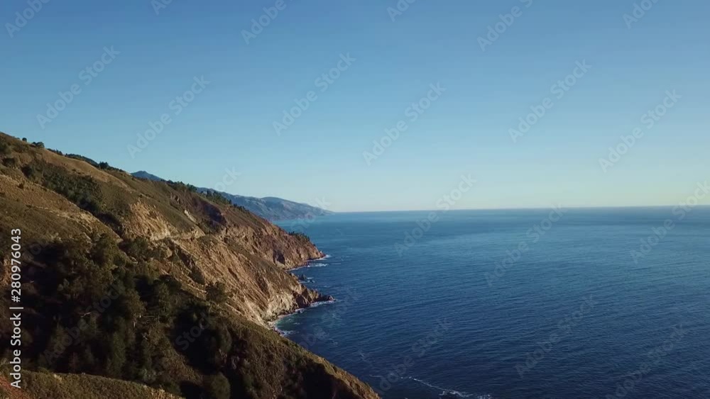 a drone shoot of a mountain and ocean a drone shoot of a mountain and ocean