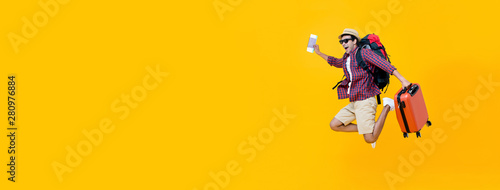 Young Asian man tourist jumping with luggage