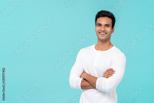 Smiling happy Indian man with arms crossed