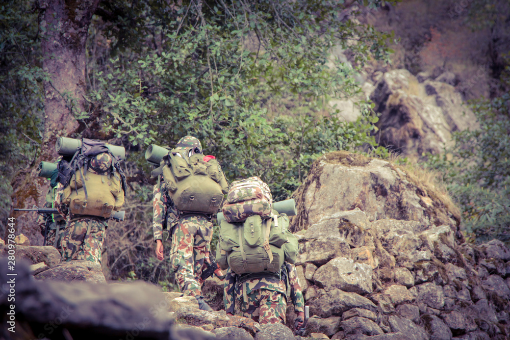 A group of Nepalese soldiers in full uniforms and weapons makes a march