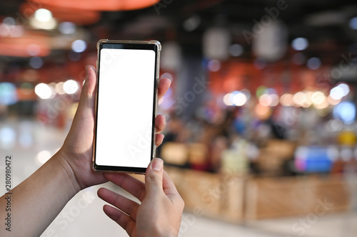 Closeup man's hands using smartphone on cafe blur background.