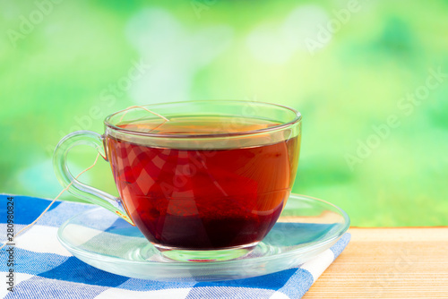 glass of tea on green background