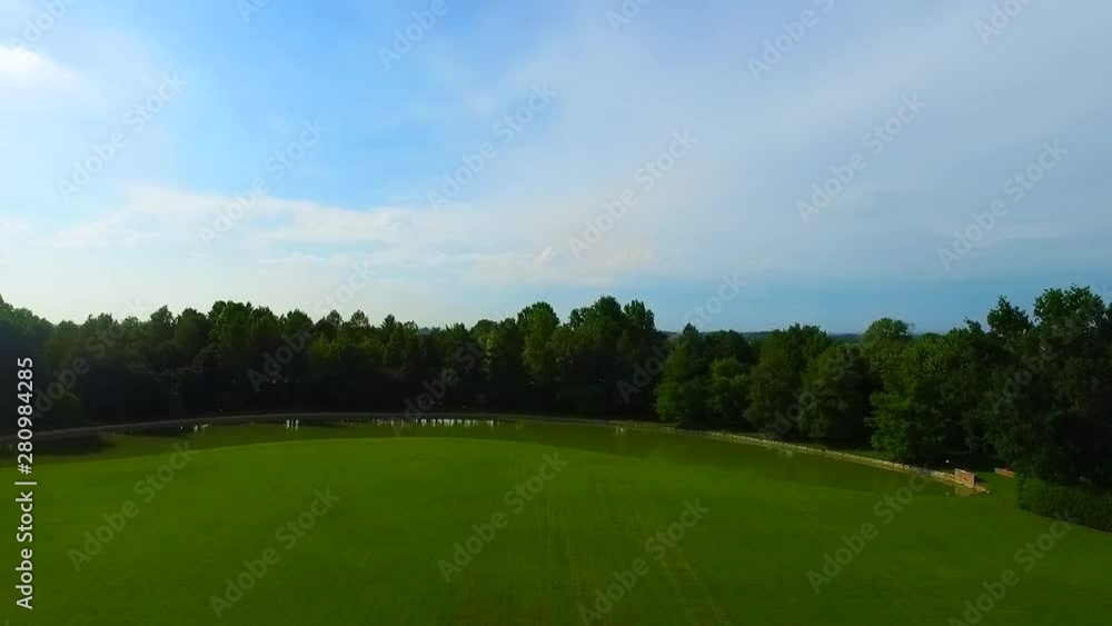 Drone view on green meadow and lake Drone view on green meadow and lake