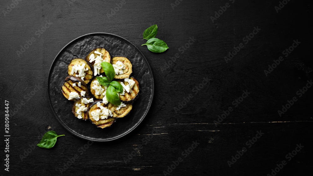 Grilled eggplant with feta cheese. Top view. Free space for your text. Grilled eggplant with feta cheese. Top view. Free space for your text.