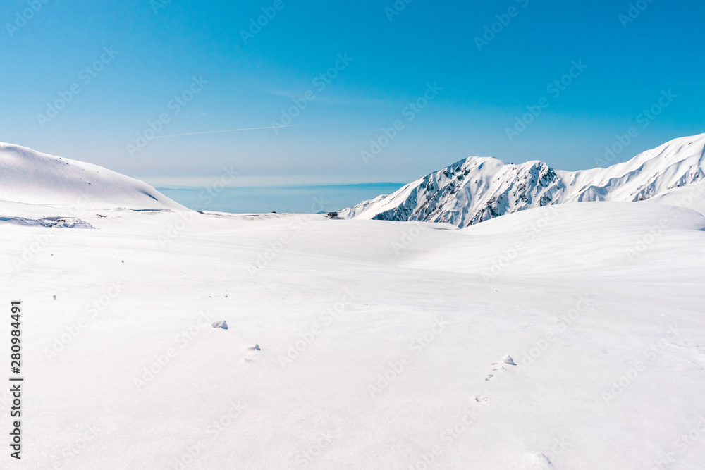 The japan alps  Tateyama Kurobe alpine  in sunshine day with  blue sky background is one of the most important and popular natural place in Toyama Prefecture, Japan.