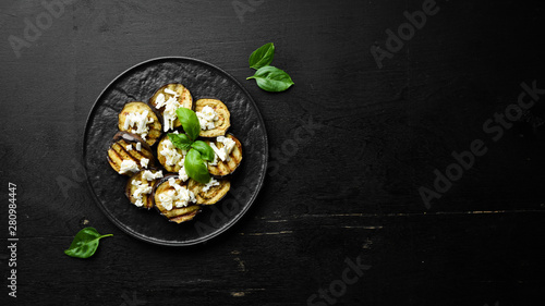 Grilled eggplant with feta cheese. Top view. Free space for your text.