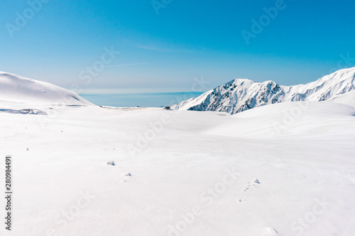 The japan alps  Tateyama Kurobe alpine  in sunshine day with  blue sky background is one of the most important and popular natural place in Toyama Prefecture, Japan. © Umarin