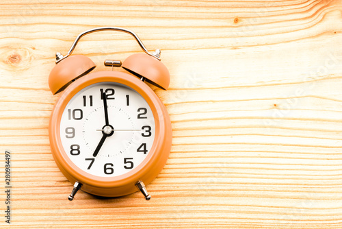 alarm clock on wooden background