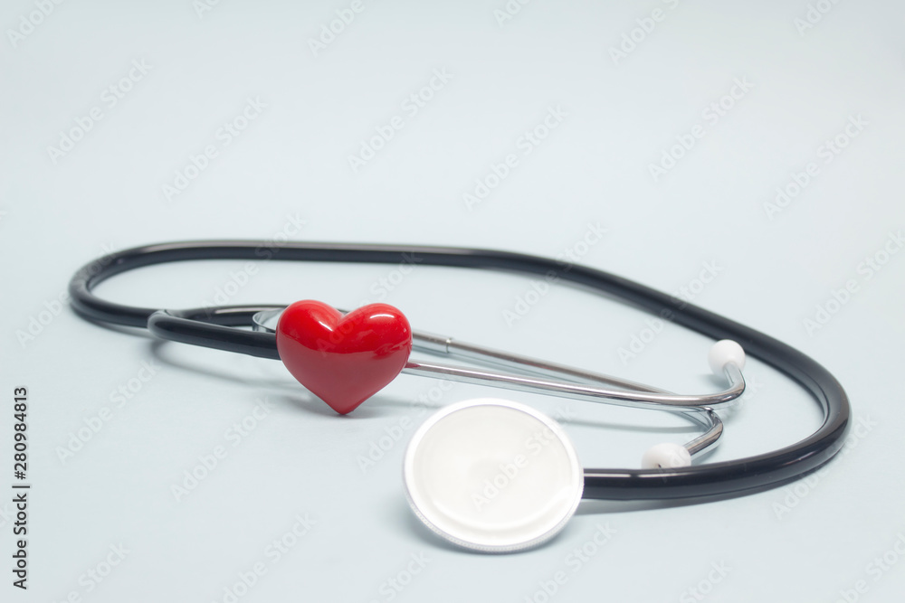 Concept on the topic of health. Stethoscope with a red heart on a light blue background. Concept on the topic of health. Stethoscope with a red heart on a light blue background.